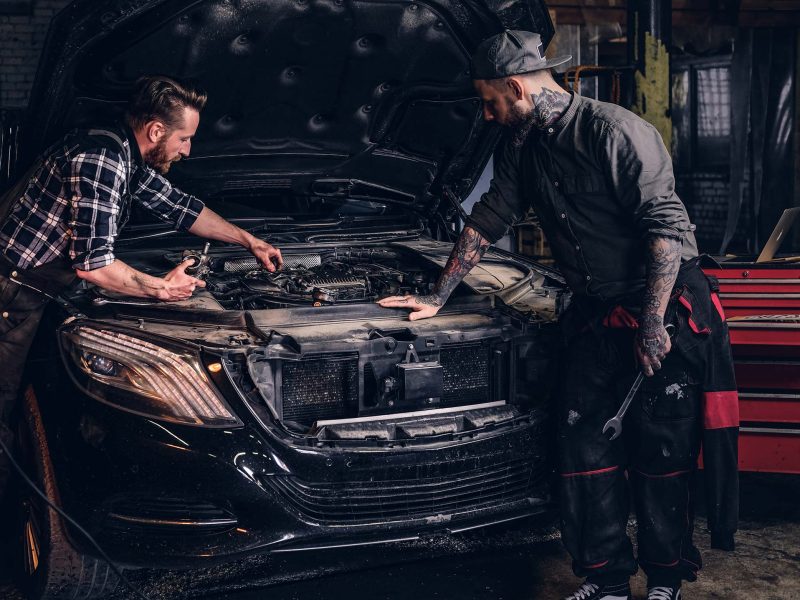 two-bearded-auto-mechanic-working-in-repair-garage-small.jpg